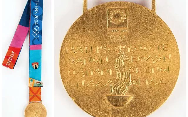 Medallas olímpicas de deportistas cubanos exhibidas como parte de un catálogo de subasta.