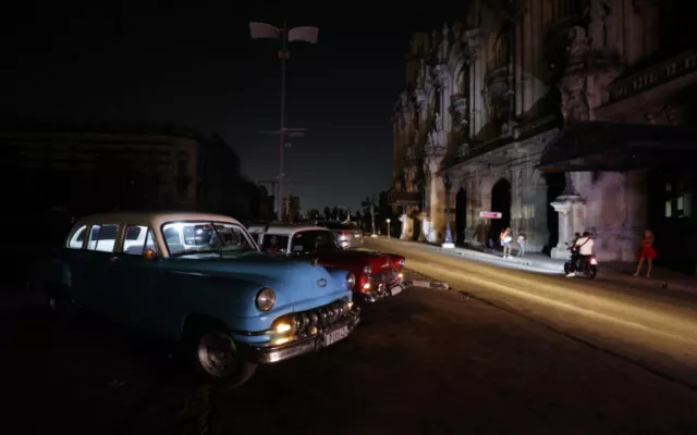 Personas caminando por una calle en La Habana durante un apagón.