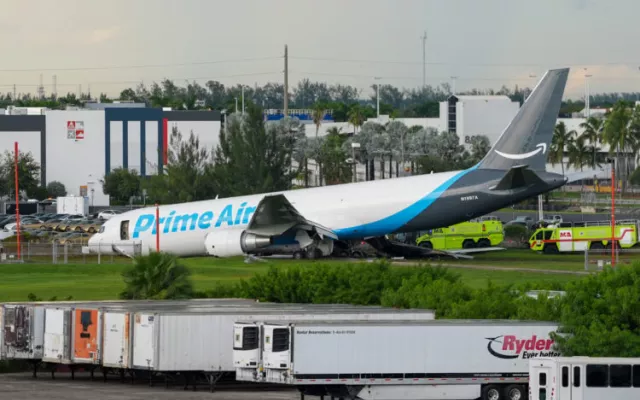 Avión de carga de Amazon accidentado en una zona adyacente a la pista del Aeropuerto Internacional de Miami tras impactar contra vehículos.