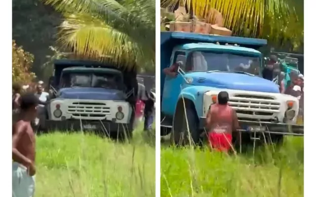 Grupo de personas rodeando un camión de carga en una calle de La Habana durante un incidente de desabastecimiento.